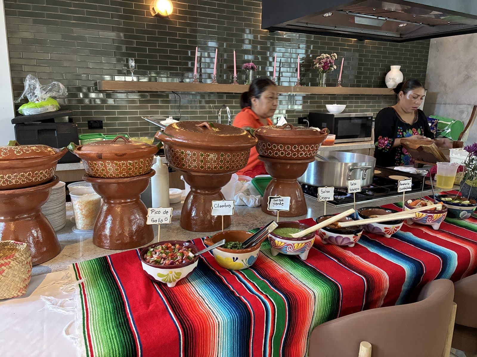 La Joya live taco bar setup with hand-painted clay pots, salsa bar, and staff cooking onsite