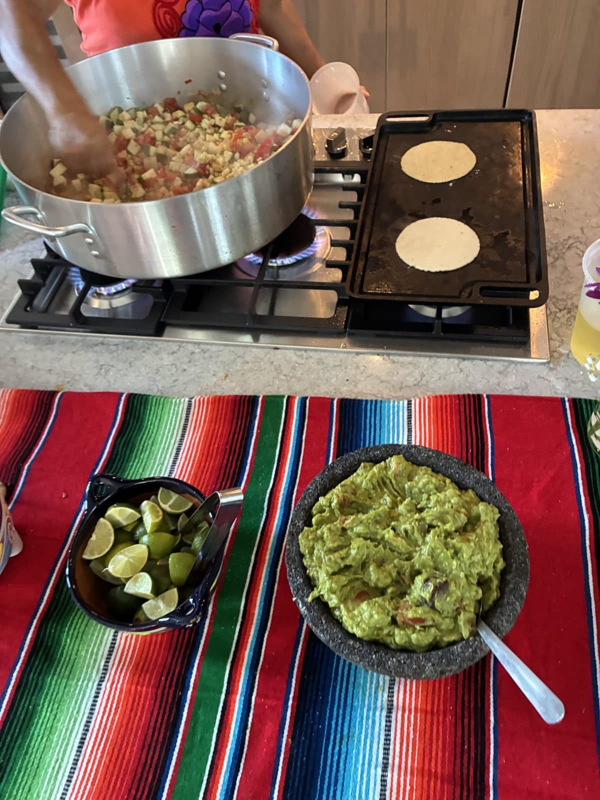 La Joya staff cooking rajas on a comal with handmade tortillas warming beside